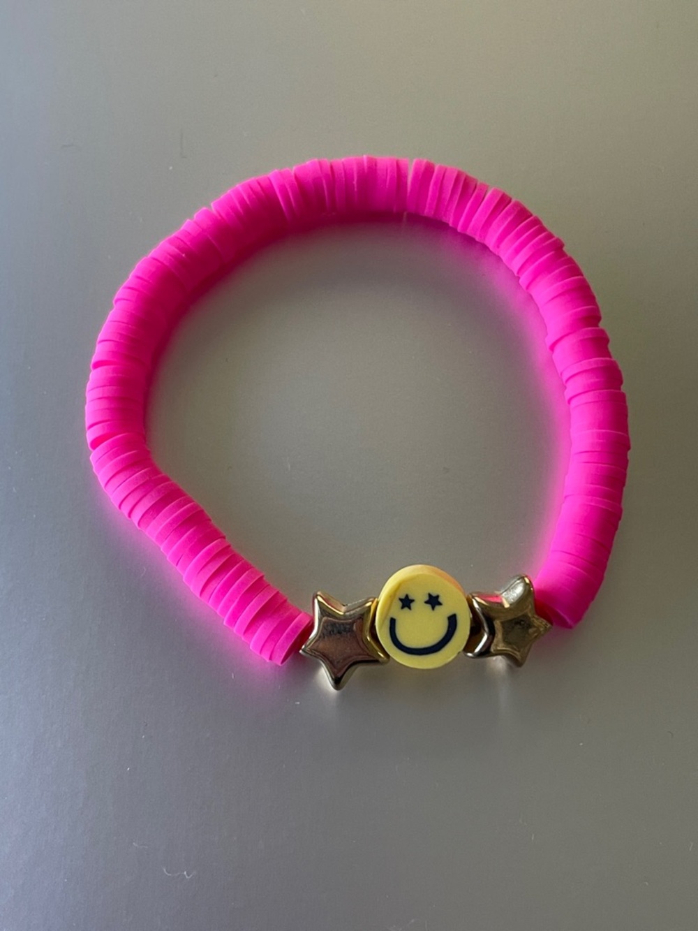 Bright Pink Smile Face Elastic Bracelet with Gold Star Accents